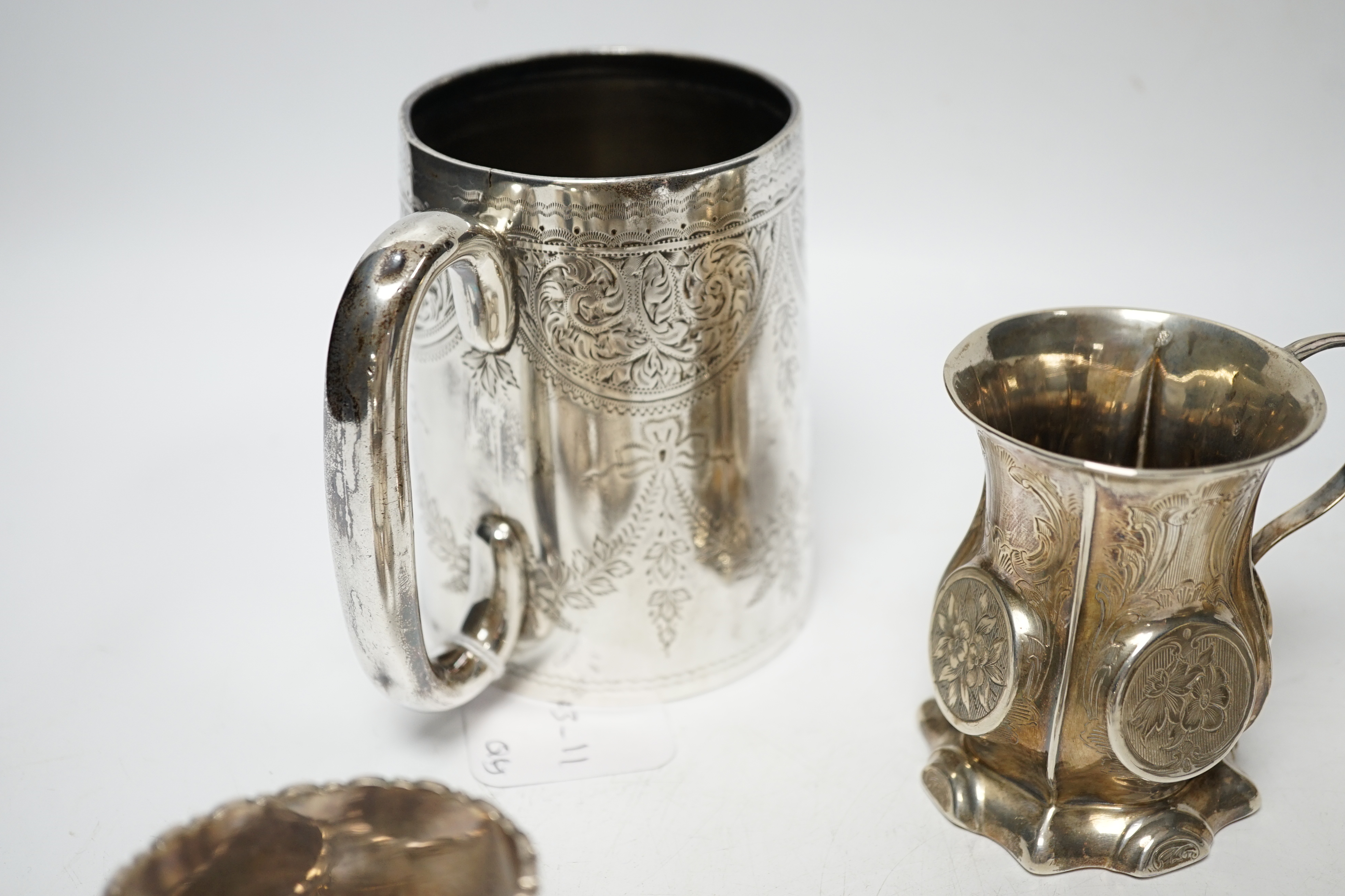 A late Victorian engraved silver mug, Hilliard & Thomason, Birmingham, 1900, 10.2cm, three assorted silver mustard pots including Victorian, a small Victorian silver christening mug and a set of six silver napkin rings,